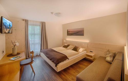 Postel nebo postele na pokoji v ubytování Apartments & Wellness Löfflerblick