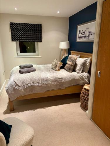 a bedroom with a bed with pillows and a window at 2 bed, 2 bath apartment in Roundhay in Moortown
