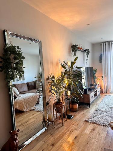 a living room with a mirror and a couch at 2 bed, 2 bath apartment in Roundhay in Moortown
