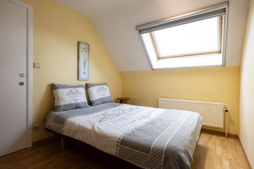 a bedroom with a large bed with a window at A little paradise Wallonie in Limelette