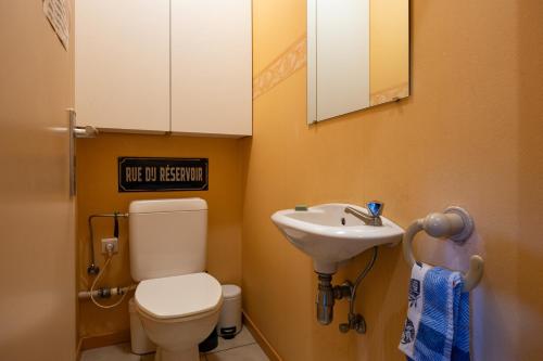 a small bathroom with a toilet and a sink at A little paradise Wallonie in Limelette