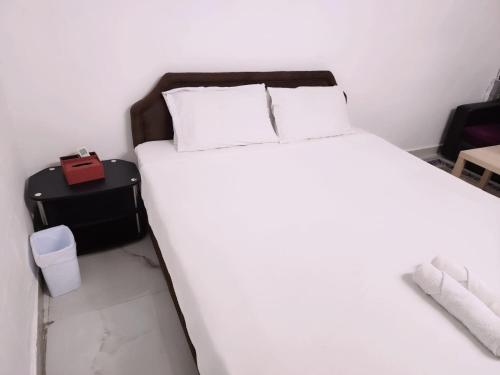 a bedroom with a white bed and a black suitcase at separate entrance room in Al Ain