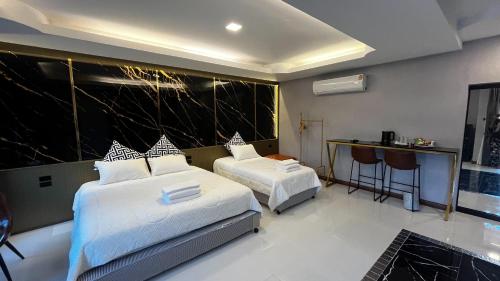 a bedroom with two beds and a table and a counter at Eastern View Resort and Pool Villa in Ban Tao Than