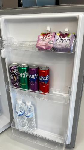 an open refrigerator filled with drinks and water bottles at Eastern View Resort and Pool Villa in Ban Tao Than