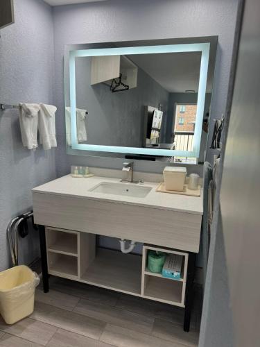a bathroom with a sink and a mirror at Quality Inn Christiansburg - Blacksburg in Christiansburg