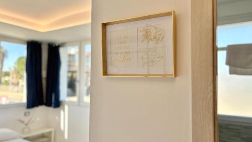 a picture hanging on a wall in a room at Romano's Luxury Stay b&b Bari in Bari