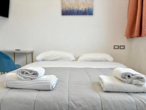 a bedroom with two beds with towels on the bed at Romano's Luxury Stay b&b Bari in Bari