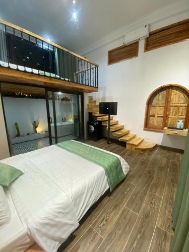 a bedroom with a large bed and a staircase at Sky Garden Moc Chau in Mộc Châu