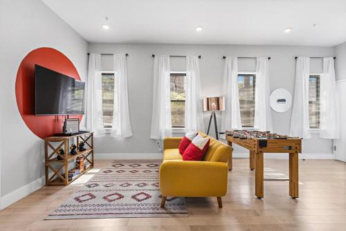 a living room with a yellow chair and a table at 1C - Ask About 20Off - Sleeps 5 - Airport 8min - NYC 30min in Newark