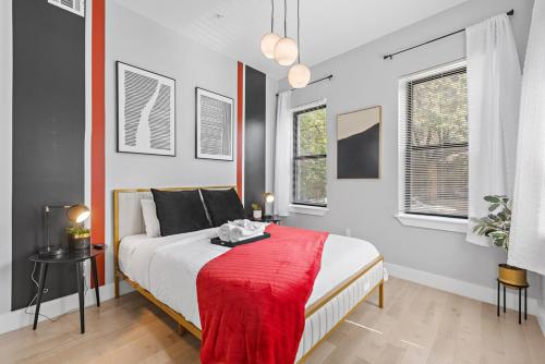 a bedroom with a bed with a red blanket on it at 1C - Ask About 20Off - Sleeps 5 - Airport 8min - NYC 30min in Newark