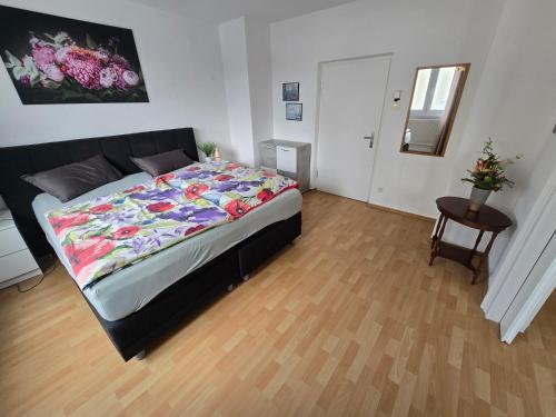 a bedroom with a large bed and a table at Ferienwohnung Sigmaringen in Sigmaringen