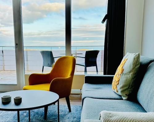 a living room with a couch and chairs and a table at Apartmenthaus Hohenfels in Helgoland