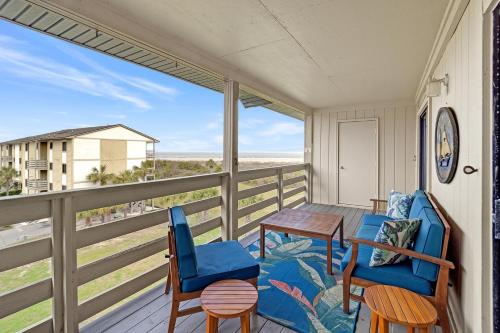a balcony with a table and chairs and a view of the beach at 33C Lighthouse Point in Tybee Island