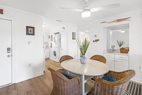 a kitchen and dining room with a table and chairs at 33C Lighthouse Point in Tybee Island