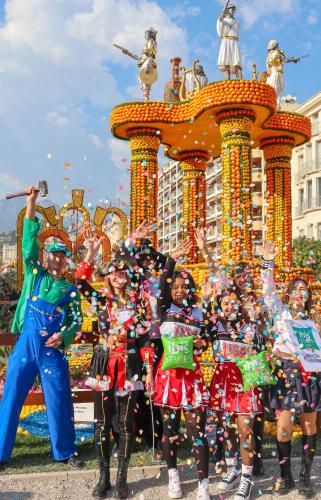 a group of women in costumes standing in front of a structure at Ibis Styles Menton Centre in Menton