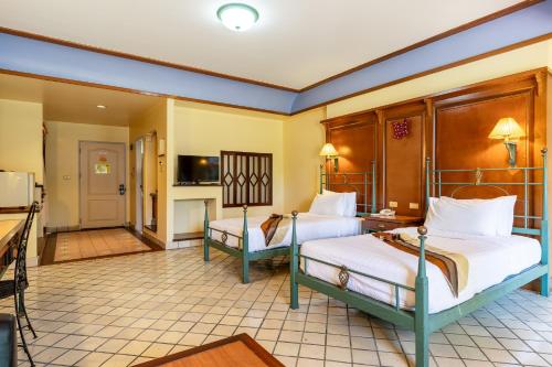 a hotel room with two beds and a kitchen at Pung-Waan Resort & Spa in Kanchanaburi