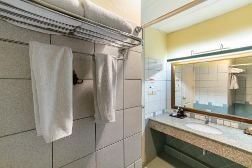 a bathroom with a sink and a mirror at Pung-Waan Resort & Spa in Kanchanaburi