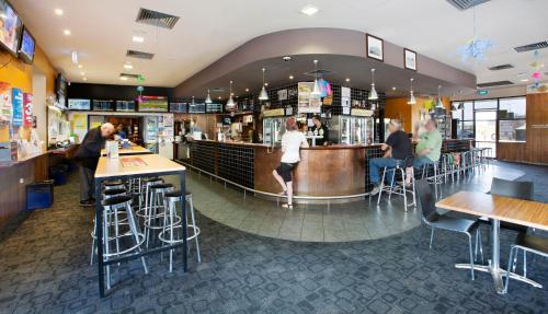 a restaurant with people sitting at the bar at Nightcap at Playford Tavern in Elizabeth