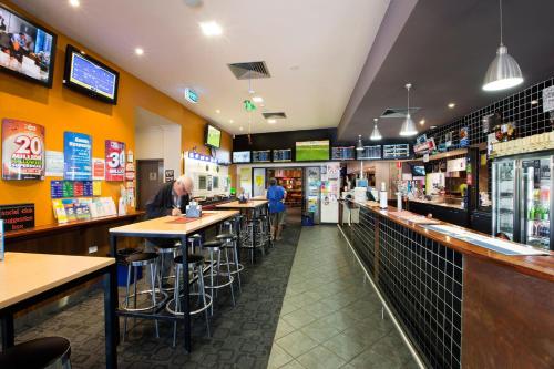 a man sitting at a bar in a restaurant at Nightcap at Playford Tavern in Elizabeth