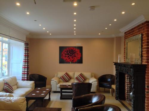 a living room with couches and a fireplace at The Royal Hotel in Mundesley