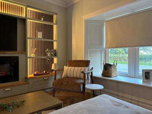 a living room with a chair and a window at Drumconnick House in Cavan