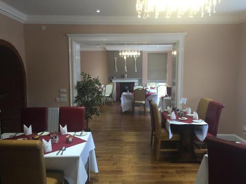 a restaurant with tables and chairs and a dining room at The Royal Hotel in Mundesley