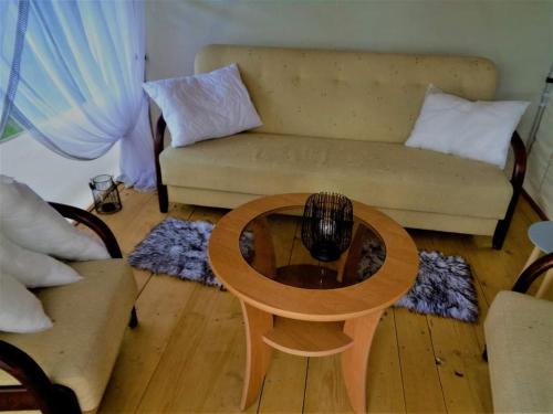 a living room with a coffee table and a couch at Biwak u Gazdy in Gosprzydowa