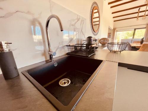 a kitchen counter with a sink and a sink at Villa 'Le Grand France' in Sainte-Marie