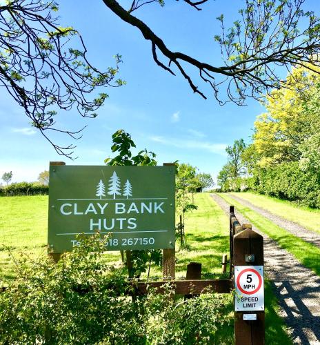 a sign for clay bank hunts on a road at Cedar Pod, Clay Bank Huts in Middlesbrough