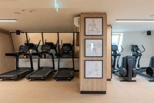 a gym with several treadmills and exercise bikes at Wyndham Wroclaw Old Town in Wrocław