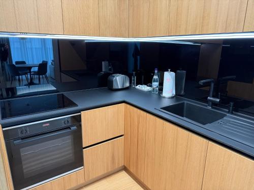 a kitchen with a sink and a counter top at Moldovei 2 Apartments by Central Park in Cluj-Napoca