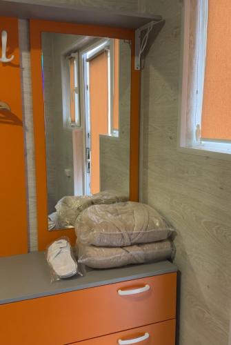 a room with a mirror and a dresser with a mirror at Sherwood Lake Hotel in Berezovka