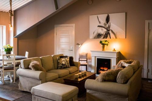 a living room with two couches and a fireplace at Widebäcks Bed & Breakfast in Landvetter