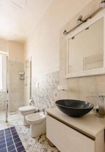 a bathroom with a sink and a toilet and a sink at Academia in Cremona