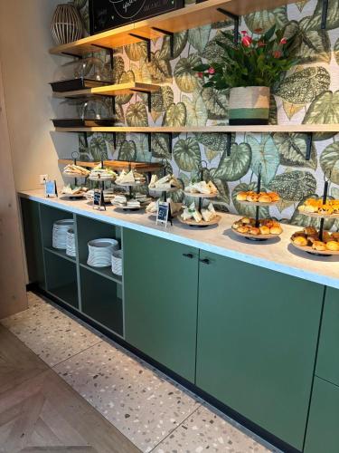 a buffet line with plates of food on display at Boutique Hotel het Witte Veen in Witteveen