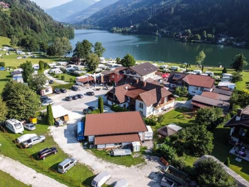 an aerial view of a village with a lake at Fischerhof Glinzner Hotel-Restaurant-Camping in Afritz