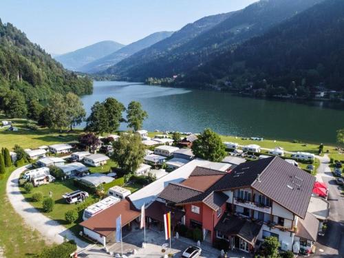 an aerial view of a resort with a lake at Fischerhof Glinzner Hotel-Restaurant-Camping in Afritz