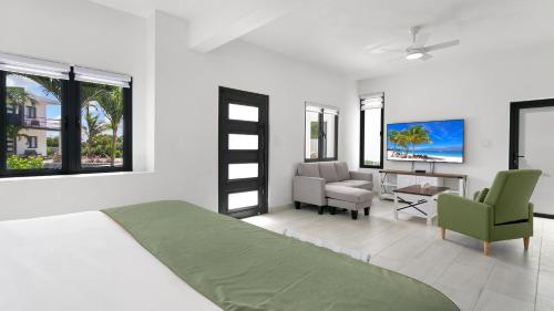 a bedroom with a bed and a living room at Genesis Residences in Meads Bay