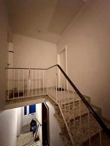 a stairway with a glass railing in a building at sleepWELL-Horstmar Zentral & Kirchennah in Horstmar