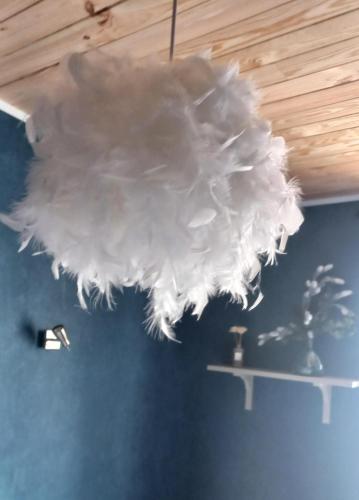 a large white chandelier hanging from a ceiling at Au Katalu in Pléaux