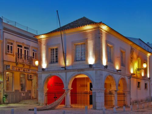 a building with a hammock in front of it at Atalaia Sol Aparthotel - tennis & heated pool in winter in Lagos
