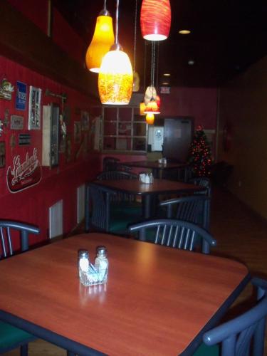 a restaurant with tables and chairs and a christmas tree at Gladstone Inn and Suites in Jamestown