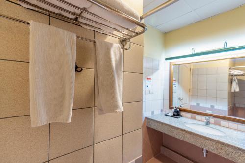 a bathroom with a sink and a mirror at Pung-Waan Resort & Spa in Kanchanaburi