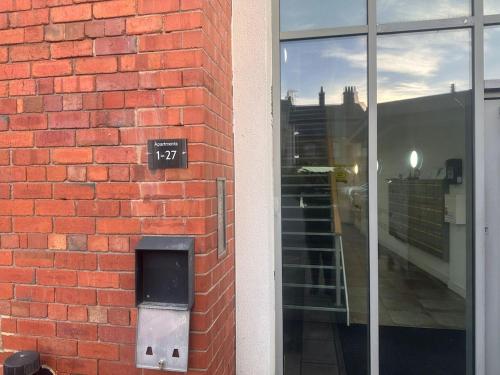 a brick wall with a pay meter on the side of a building at Top floor 2 bedroom retreat in Morley