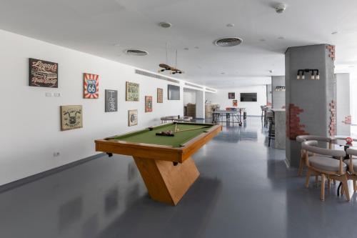 a room with a pool table in the middle of it at Meraki Resort Sharm El Sheikh Adults only in Sharm El Sheikh