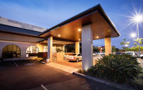 a building with a car parked in a parking lot at Nightelier Mermaid Waters in Gold Coast