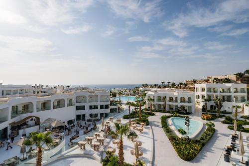 an aerial view of a resort with palm trees and buildings at Meraki Resort Sharm El Sheikh Adults only in Sharm El Sheikh