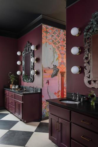 a bathroom with two sinks and a large painting on the wall at The Menagerie in Fredericksburg