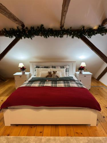a bedroom with a bed with a teddy bear on it at Homestead at Stefka's in Mokronog