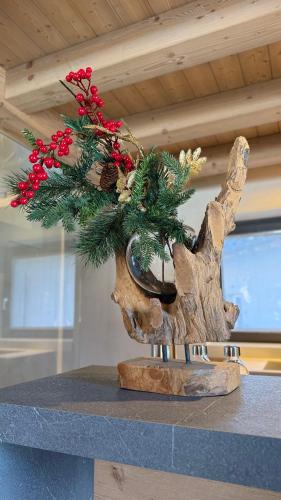 a vase with a christmas plant on a table at Lo Chalet Incantato del Maso K in Folgaria